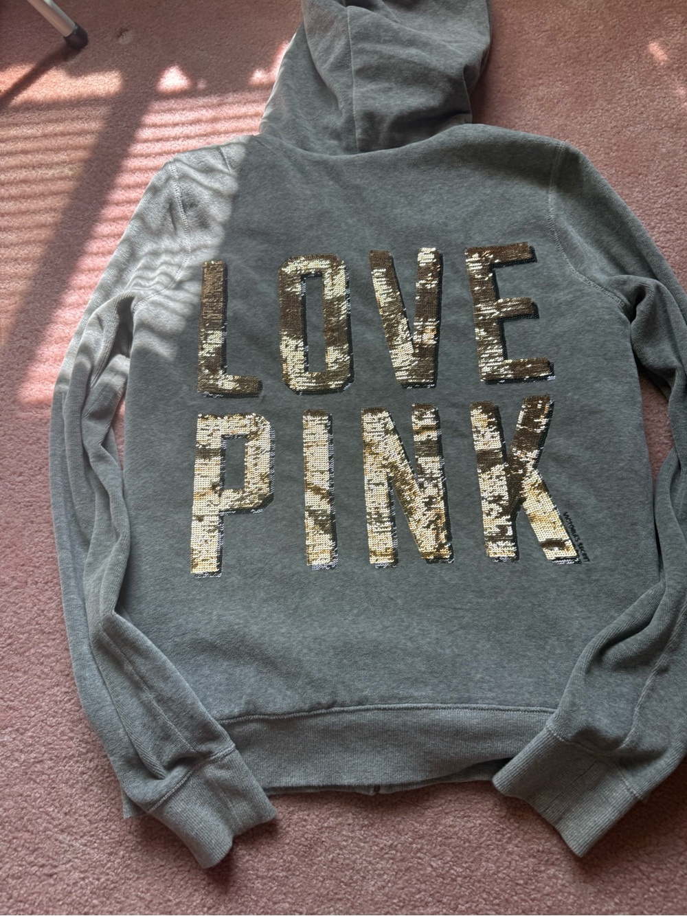 Grey zip up hoodies with fur lining and gold accents
